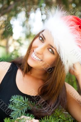 Portrait of a sexy young female smiling in a park and looking at