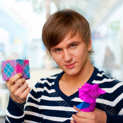 Portrait of young man inside shopping mall standing relaxed and 