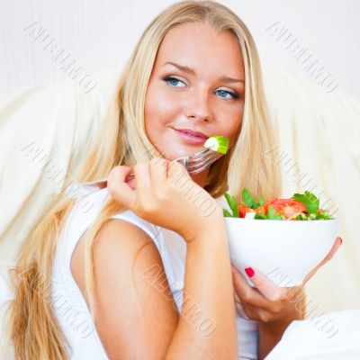 Closeup portrait of a beautiful slender girl eating healthy food