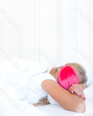 Closeup portrait of a cute young woman sleeping on the bed weari