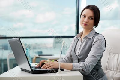 Smiling pretty business woman with microphone. She is salesperso