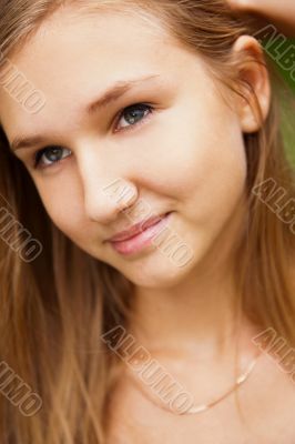 Portrait of the young beautiful smiling woman outdoors
