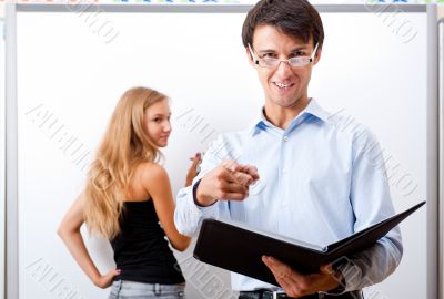 Closeup of adult teacher with student presenting her work on whi