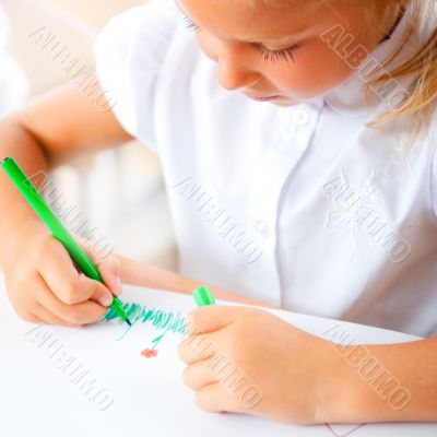 Little girl looking for a drawing concept wile painting picture 