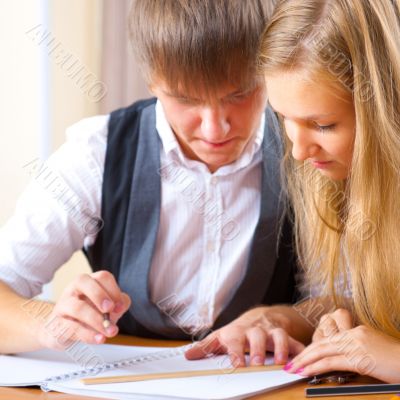 Portrait of college students working indoors looking happy