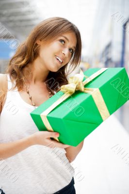 Portrait of young excited pretty woman standing inside shopping 