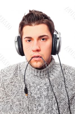Closeup portrait of sad young man wearing domestic sweater holdi