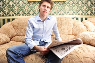 Closeup portrait of young man with newspaper 