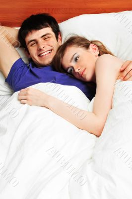 Young man and woman in bed. Couple.