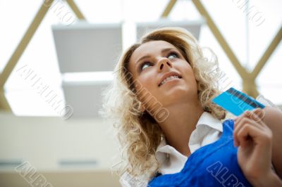 Beautiful shopping woman holding a credit card