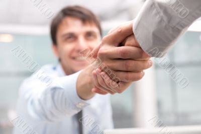 Closeup of business people shaking hands over a deal
