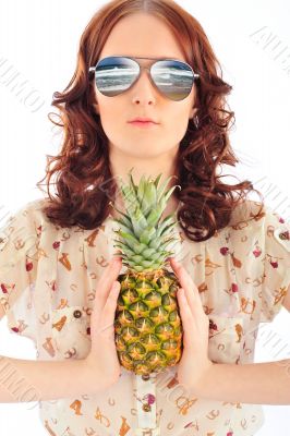 Closeup portrait of woman in sunglasses holding pineapple in her