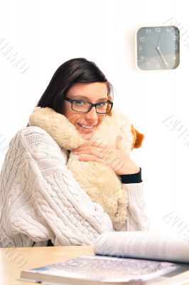 Closeup portrait of a young woman embracing her soft toy