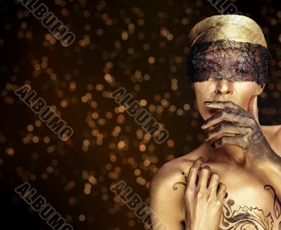 Portrait of young dancing girl with golden body art 