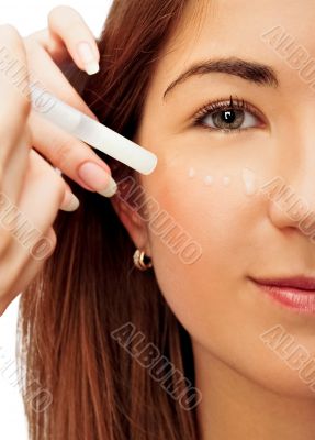 Face part of beautiful woman with cream on face on white backgro