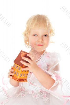 Closeup portrait of little caucasian girl holding house building