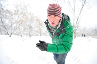 Closeup portrait of young man running in winter park
