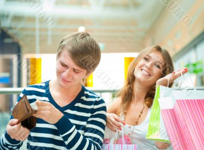 Woman can`t stop shopping at mall, making her man or boyfriend s Woman can`t stop shopping at mall, making her man or boyfriend s