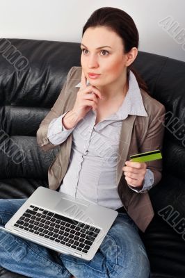 Portrait of beautiful business woman with laptop and credit card