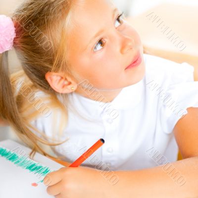 Little girl looking for a drawing concept wile painting picture 