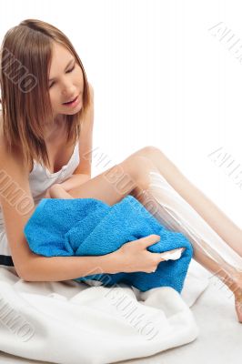 Cute woman shaving her legs