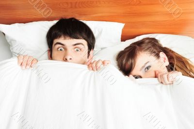 Young man and woman in bed. Couple.