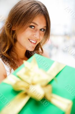 Portrait of young excited pretty woman standing inside shopping 
