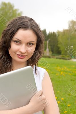 Portrait of the young beautiful smiling woman outdoors
