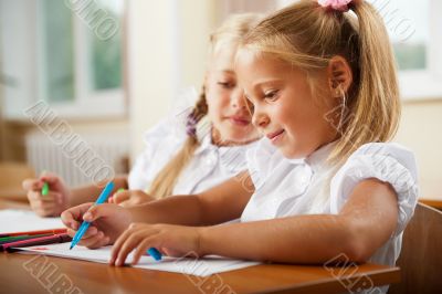 Little girls drawing pictures and writing letters to Santa Claus