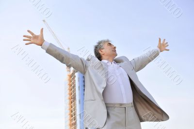 Portrait of a businessman with arms open.