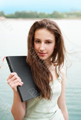 Beautiful brunette woman resting on the beach