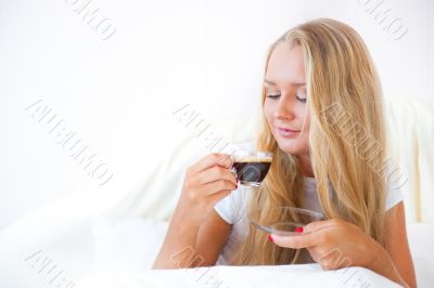 Closeup portrait of a pretty young female having a cup of coffee