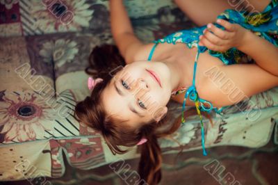 Artistic lifestyle shot of young little girl laying on sofa. Nat