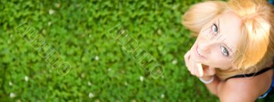 Smiling beautiful woman laying on grass