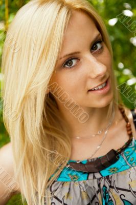 Portrait of a happy young woman posing in a park - Outdoor