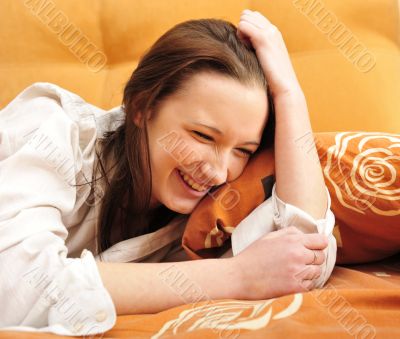 Closeup portrait of young pretty girl laying on her bed