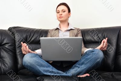 Portrait of young business woman sitting with a laptop on comfor