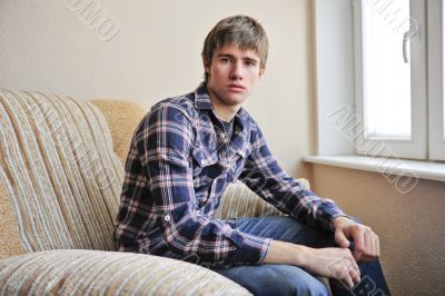 Happy young handsome man at home