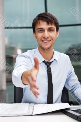 Happy mature business man offering a welcoming hand