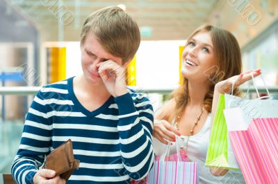 Woman can`t stop shopping at mall, making her man or boyfriend s