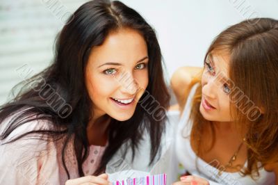 Two excited shopping woman together inside shopping mall. Horizo