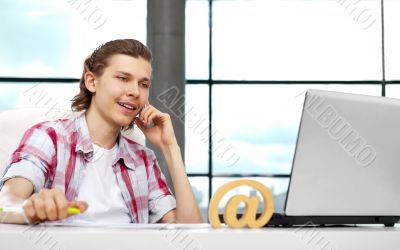 Portrait of handsome young man working with laptop on freelance 