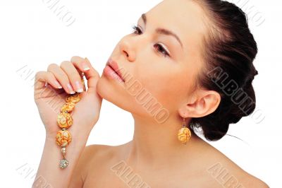Beauty and health of young woman wearing jewelry - isolated on w