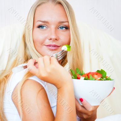 Closeup portrait of a beautiful slender girl eating healthy food