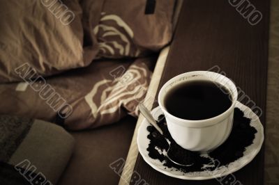 warm cup of coffee on brown background