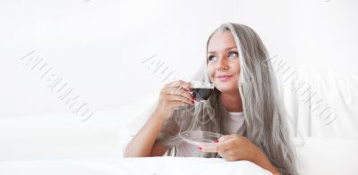 Closeup portrait of a pretty senior female having a cup of coffe