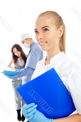 Portrait of a doctor with one of her co-workers talking with a p