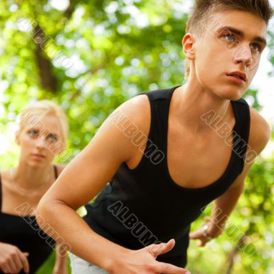 Closeup Portrait of Young Couple Jogging In Park