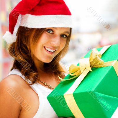 Portrait of young excited pretty woman standing inside shopping 