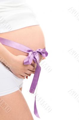Image of pregnant woman touching her belly with hands